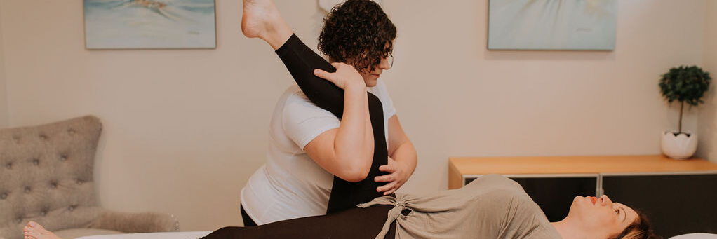 Mindy stretching a client's range of motion